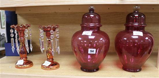 A pair of Victorian gilt cranberry glass lustre hung vases and a pair of cranberry glass lidded vases jars